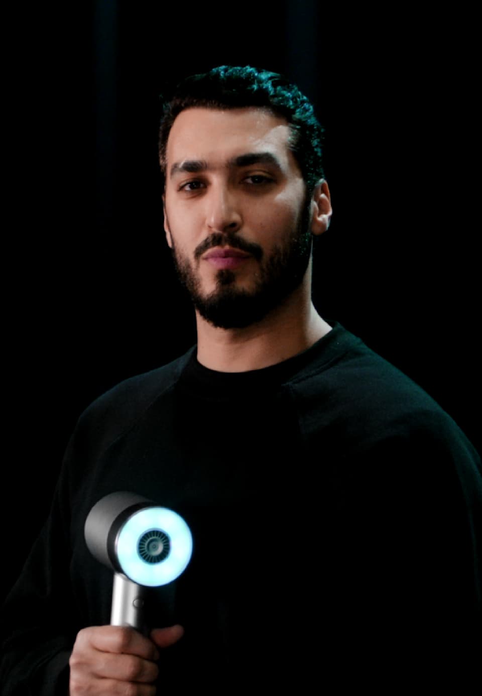 Portrait of Nabil Harlow holding the AirLight Pro hairdryer